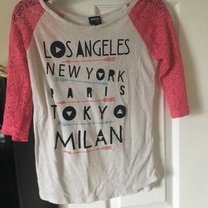 Pink t-shirt with a list of places